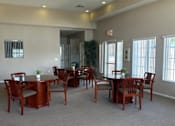 Thumbnail 21 of 27 - A room with a dining table and chairs.