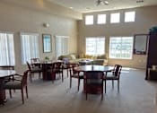 Thumbnail 20 of 27 - A spacious room with a dining table and chairs.