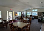 Thumbnail 11 of 14 - A large room with tables and chairs and a couch.