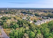 Thumbnail 11 of 14 - A bird's eye view of a residential area with houses and trees.