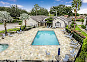 Thumbnail 26 of 27 - A pool surrounded by chairs and umbrellas.