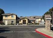 Thumbnail 1 of 14 - A row of houses with a red curb in front.
