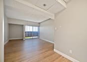 Thumbnail 8 of 31 - A room with wooden floors and white walls.