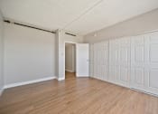 Thumbnail 13 of 31 - A room with a white door and a white wardrobe.