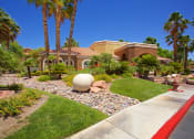 Thumbnail 5 of 31 - a home with palm trees and a globe in the front yard