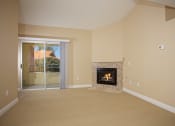 Thumbnail 8 of 31 - a living room with a fireplace and a sliding glass door