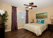 Thumbnail 30 of 31 - a bedroom with a bed and a ceiling fan