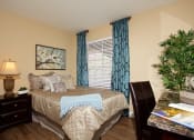 Thumbnail 25 of 31 - a bedroom with a bed and a christmas tree