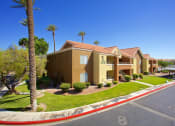 Thumbnail 24 of 31 - a row of yellow houses with palm trees and a street