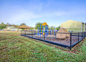 Thumbnail 3 of 14 - A playground with a blue swing set and a yellow slide.