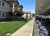 Thumbnail 17 of 27 - A row of houses with cars parked on the street.
