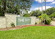 Thumbnail 1 of 27 - A sign that says "The Ivy Apartment Homes" in front of a stone wall.