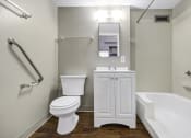 Thumbnail 19 of 27 - a bathroom with a toilet and a sink and a bath tub