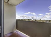 Thumbnail 12 of 27 - a balcony with a view of the city and a blue sky