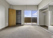 Thumbnail 11 of 27 - a empty room with a door to a balcony