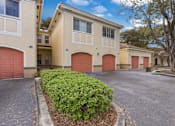 Thumbnail 2 of 20 - A row of houses with red garage doors.
