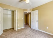 Thumbnail 15 of 15 - A room with a carpeted floor and a ceiling fan.