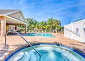 Thumbnail 1 of 15 - A pool with a slide in the middle of it.