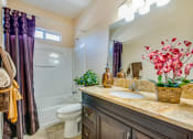 Thumbnail 12 of 25 - a bathroom with a sink and a toilet and a shower