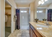 Thumbnail 13 of 25 - a bathroom with a shower and a sink and a mirror