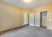 Thumbnail 17 of 25 - an empty living room with two doors and a closet