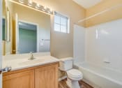 Thumbnail 14 of 25 - a bathroom with a sink toilet and a tub