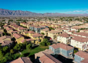 Thumbnail 1 of 25 - an aerial view of a neighborhood of houses with mountains in the background