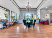 Thumbnail 4 of 23 - a large dining room with a table and chairs and a chandelier