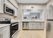 Thumbnail 5 of 23 - a kitchen with stainless steel appliances and white cabinets