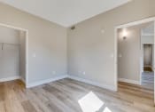 Thumbnail 14 of 23 - an empty living room with wood flooring and a closet