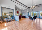 Thumbnail 16 of 23 - a living room and dining room with a table and chairs
