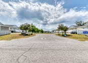 Thumbnail 18 of 25 - A residential area with houses and a paved road.