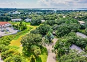 Thumbnail 12 of 25 - Aerial view of apartment complex with trees