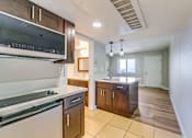 Thumbnail 24 of 32 - a kitchen with an island and a stove and a microwave