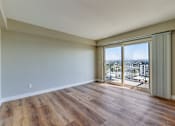 Thumbnail 25 of 32 - an empty living room with sliding glass doors to a balcony