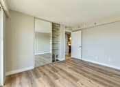 Thumbnail 26 of 32 - a bedroom with a closet and a hard wood floor