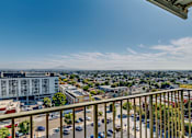 Thumbnail 14 of 32 - a balcony with a view of a city and the ocean
