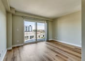 Thumbnail 15 of 32 - a living room with a large window and wooden floors