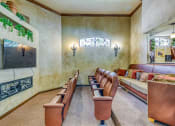 Thumbnail 22 of 25 - a theater room with leather chairs and a couch