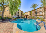 Thumbnail 6 of 25 - a swimming pool with an apartment building in the background