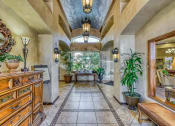 Thumbnail 20 of 25 - the entryway of a house with a tiled floor and a tree in the