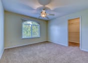 Thumbnail 24 of 25 - an empty room with a ceiling fan and a window
