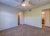 Thumbnail 12 of 25 - the living room of an empty house with a ceiling fan