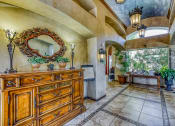 Thumbnail 8 of 25 - the entryway of a house with a dresser and a large window