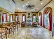 Thumbnail 21 of 25 - a large living room with a bar and a fireplace