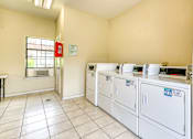 Thumbnail 31 of 32 - A laundry room with washers and dryers.