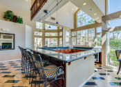 Thumbnail 25 of 30 - the large bar in the kitchen of a house with large windows
