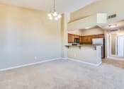 Thumbnail 22 of 30 - an empty living room with a kitchen in the corner