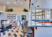 Thumbnail 24 of 30 - the living room and kitchen of a house with a bar and couches