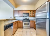 Thumbnail 26 of 30 - an updated kitchen with stainless steel appliances and granite counter tops
